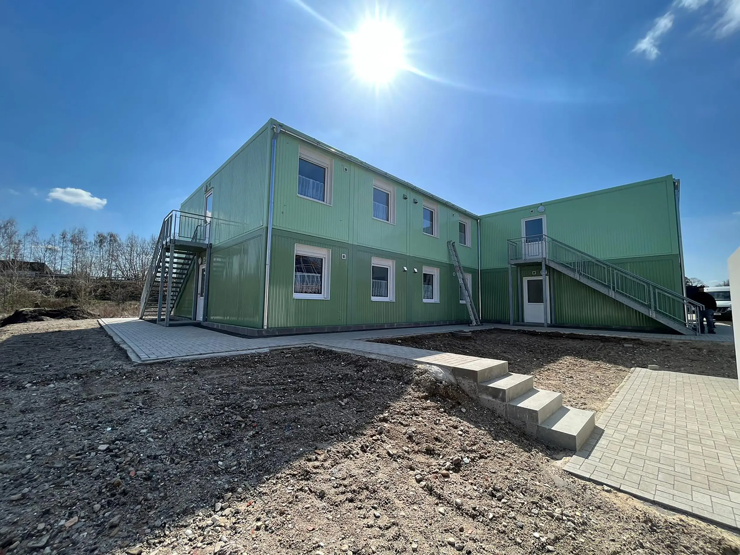 Außenansicht der zweistöckigen Flüchtlingsunterkunft in Rheine, bestehend aus grünen Containermodulen